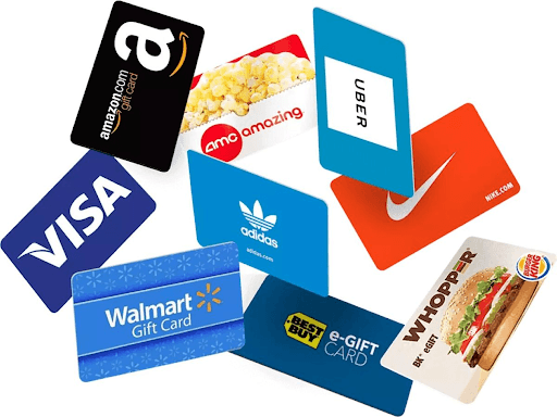 A collection of gift cards for different brands on a table.